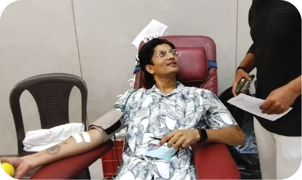 Donor lying on chair smiling during blood donation process